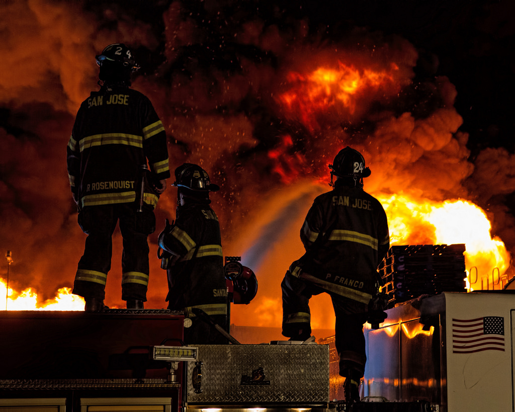 Firefighters overlooking a smokey blaze